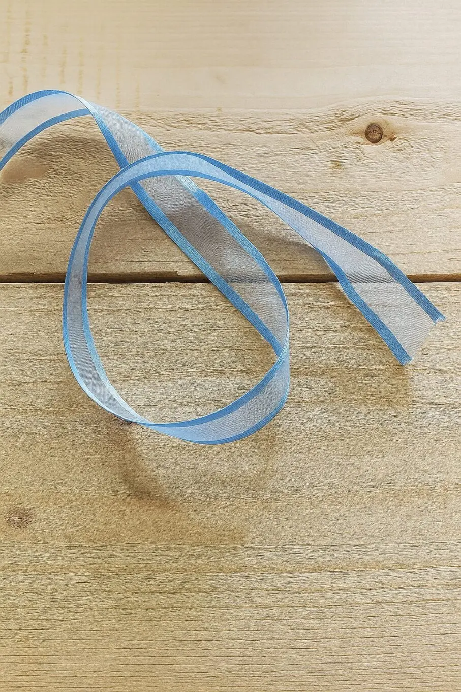 light blue ribbon light blue ribbon 20250707 1308 blue ribbon on wood remix 01jzk11nvmfbbv1bczk6vr6aht